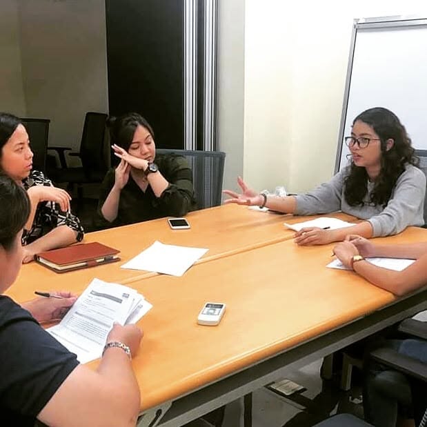 Abigail leading a discussion with her team