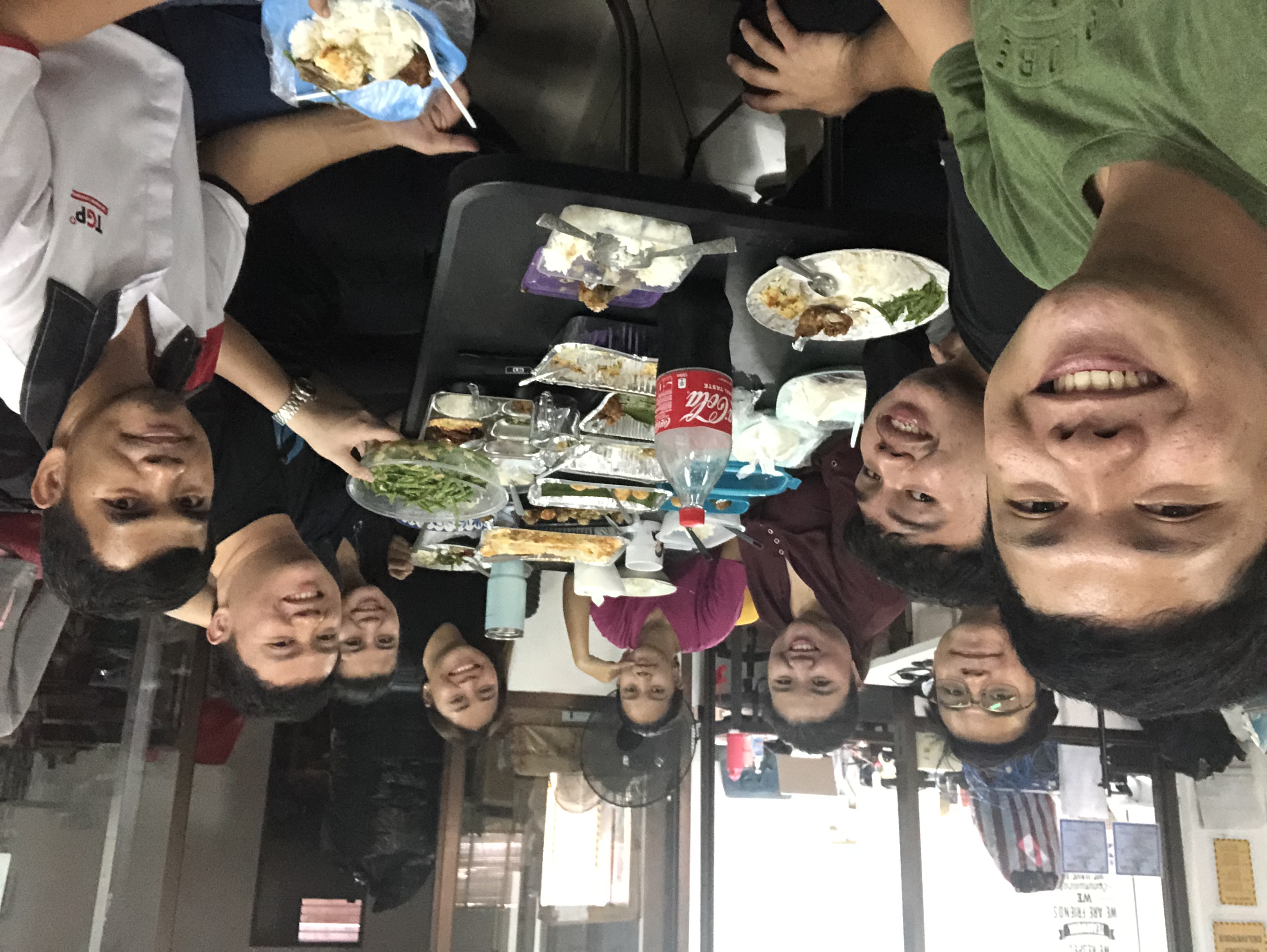 Arlene sharing a meal with her team around the same table